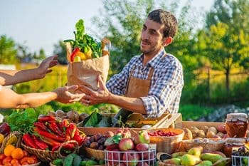 Vendor selling fresh produce at farmers market