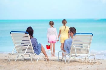 Parents watching kids at beach